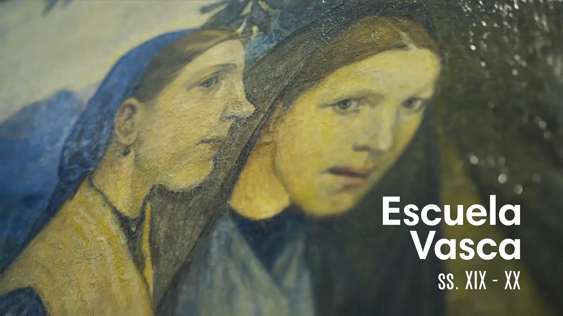 Fotograma del vídeo: detalle muy cercano de una pintura de dos mujeres con pañuelo, con la textura de la pintura a la vista y el rótulo «Escuela Vasca ss. XIX-XX»